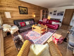 a living room with a couch and a table at Chalet Chalet Aglaia by Interhome in Crans-Montana