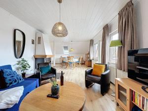 a living room with a blue couch and a table at Apartment Am Sternberg 224 by Interhome in Frankenau