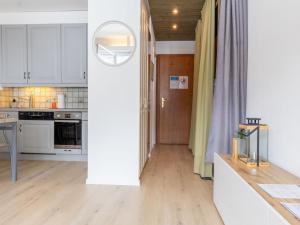 a kitchen with white cabinets and a wooden floor at Studio Rosablanche D63 by Interhome in Siviez +20 photos