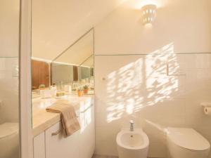 a bathroom with a toilet and a sink and a mirror at Apartment Nautilus by Interhome in Arzachena
