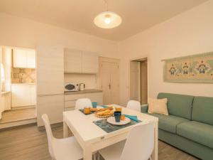 a living room with a table and a couch at Apartment Nautilus by Interhome in Arzachena +18 photos