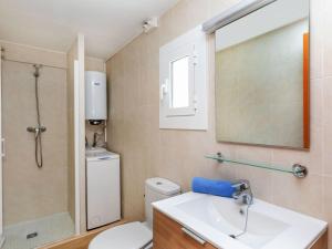a bathroom with a toilet and a sink and a shower at Apartment Blue Ocean-3 by Interhome in Llança