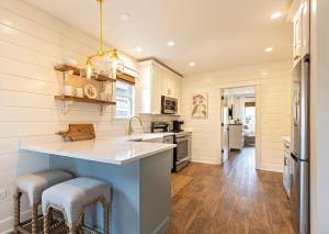 a kitchen with a counter and stools at Kildahl House - Boutique Farmhouse Suite #1 in West Dundee