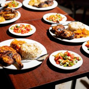 a table full of plates of food with chicken and rice at The Sea side camp nuweiba in Nuweiba +23 photos