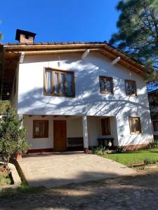 a white house with windows and a driveway at Vistas NO 5 in Mazamitla +8 photos