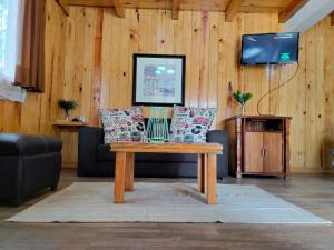 a living room with a couch and a table at Vistas NO 5 in Mazamitla