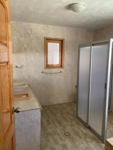 a bathroom with a shower and a sink and a mirror at Vistas NO 5 in Mazamitla