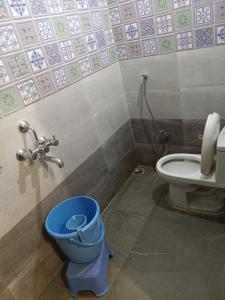 a bathroom with a blue toilet and a sink at Hotel Sanwariya Palace in Haridwār