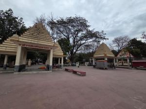 a group of buildings with peaked roofs and benches at Hotel Sanwariya Palace in Haridwār +42 photos