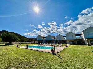 a house with a large yard with a swimming pool at Dimis Luxury Suites in Paralia Sikias