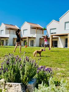 two girls playing frisbee with a dog in a yard at Dimis Luxury Suites in Paralia Sikias +15 photos