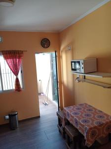 a room with a bed and a clock on the wall at Duplex a pazos del muelle in Mar de Ajó