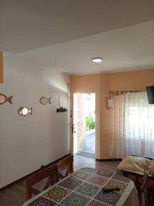 a bedroom with a bed and a door to a yard at Duplex a pazos del muelle in Mar de Ajó