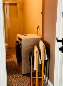 a washer and dryer sitting in a bathroom at Refugium Lodziense II - Quiet luxury in the center of Lodz in Łódź