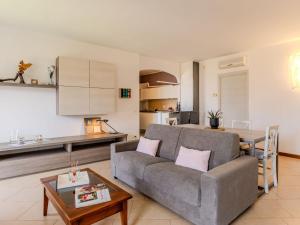 a living room with a couch and a table at Apartment di Lalla by Interhome in Lierna
