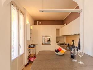 a kitchen with a counter with two wine glasses at Apartment di Lalla by Interhome in Lierna