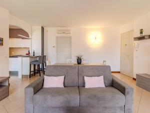 a living room with a couch and a kitchen at Apartment di Lalla by Interhome in Lierna