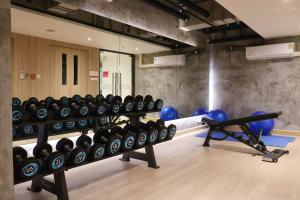 a gym with dumbbells and a bunch of balls at TARA Bangkok Riverside Formerly GLOW Bangkok Riverside in Bangkok