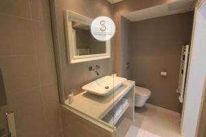 a bathroom with a sink and a toilet at Côté Chapelle Arles Centre in Arles +8 photos