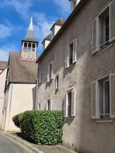 a building with a clock tower in the background at Centre Chartres Parking privé Climatiseur in Chartres