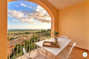 a white table and chairs on a balcony with a view at Luce di Mare, Vista Mare Sea View in Is Molas 
