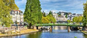 a bridge over a river in a city with buildings at Osez Nantes cœur de ville! T3 chic et spacieux in Nantes