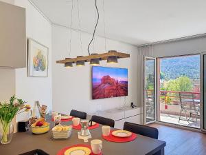 a dining room with a table with chairs and a dining room at Apartment Caslago by Interhome in Caslano