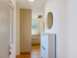 a kitchen with a refrigerator and a mirror on the wall at Apartment Caslago by Interhome in Caslano +19 photos