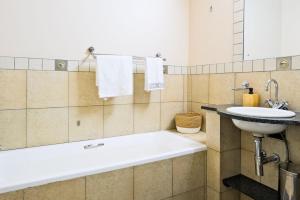 a bathroom with a sink and a bath tub at Isiphephelo Property in Johannesburg