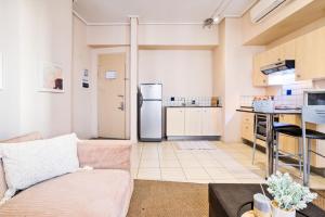 a living room with a couch and a refrigerator at Isiphephelo Property in Johannesburg