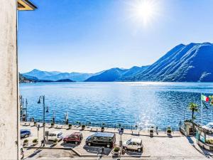 a view of a large body of water with cars parked at Apartment Martino by Interhome in Argegno