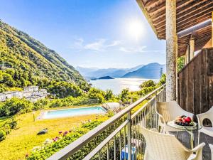 a balcony with a view of the water and mountains at Apartment Borgo Castello-4 by Interhome in Argegno +13 photos