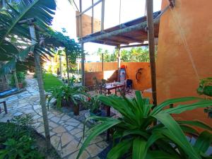 an outdoor patio with a table and some plants at Pousada Kite Guajiru in Itarema +97 photos