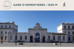 a large white building with a clock tower on top at Cinéma Privé & Sauna - Nuit Romantique in Armentières