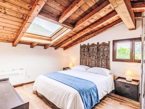 a bedroom with a large bed and wooden ceilings at Apartment Borgo Castello-9 by Interhome in Argegno