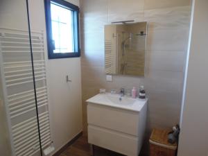 a white bathroom with a sink and a mirror at Coeur de Bonnieux in Bonnieux +12 photos