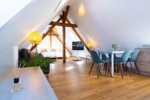 a room with a table and chairs in a attic at BetterBeds Berlin in Berlin