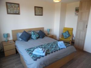 a bedroom with a bed with towels and a chair at Coeur de Bonnieux in Bonnieux