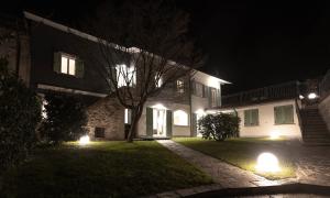 a house with lights in the yard at night at La casa del lupo in Colico