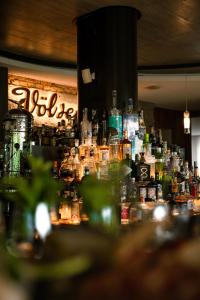 a large group of bottles of alcohol on a bar at LeFie in Vols am Schlern