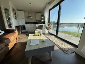 a living room with a table and a large window at Lakeside Apartment in Enniskillen
