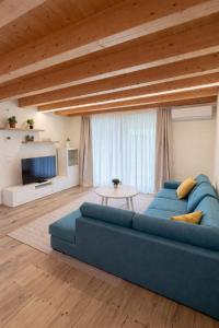 a living room with a blue couch and a table at Villa Alberti - Elegant, Spacious & Bright Villa in Casa Reali