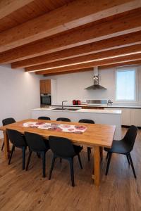 a kitchen with a wooden table and chairs in a room at Villa Alberti - Elegant, Spacious & Bright Villa in Casa Reali +10 photos