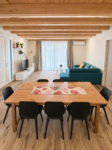 a living room with a wooden table and chairs at Villa Alberti - Elegant, Spacious & Bright Villa in Casa Reali