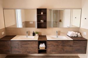 a bathroom with two sinks and a large mirror at Villa Alberti - Elegant, Spacious & Bright Villa in Casa Reali