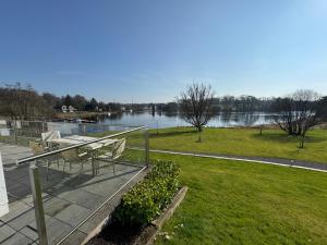 a balcony with chairs and a view of a river at Lakeside Apartment in Enniskillen