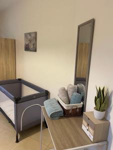a bathroom with a mirror and a basket of towels at The root loft Trikala in Tríkala