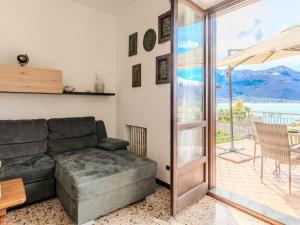 a living room with a couch and a patio at Apartment Onda Blu by Interhome in Gera Lario