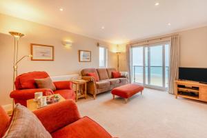 a living room with red furniture and a television at 3 Bed in Putsborough oc-flt20 in Croyde