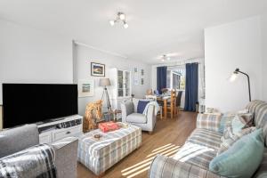 a living room with two couches and a flat screen tv at 2 Bed in Seahouses oc-86092 in North Sunderland